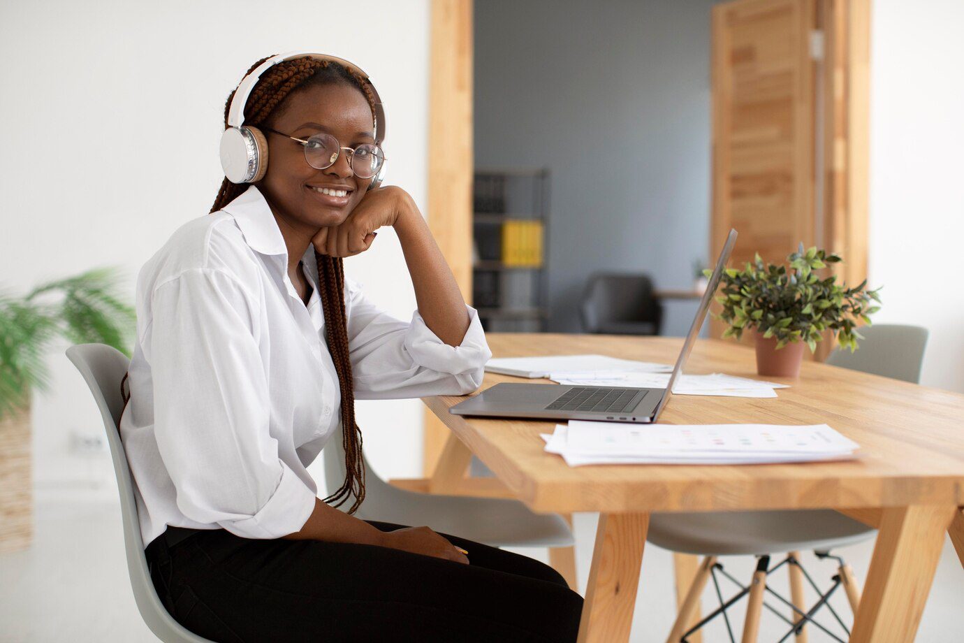 young-woman-working-with-her-headphones_23-2149116565